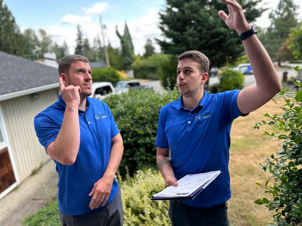 two male roofing experts discussing