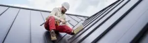 man working on a metal roof