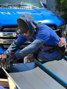 a man cutting roofing sheets