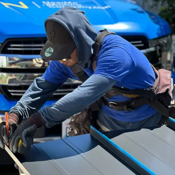 a man cutting roofing sheets