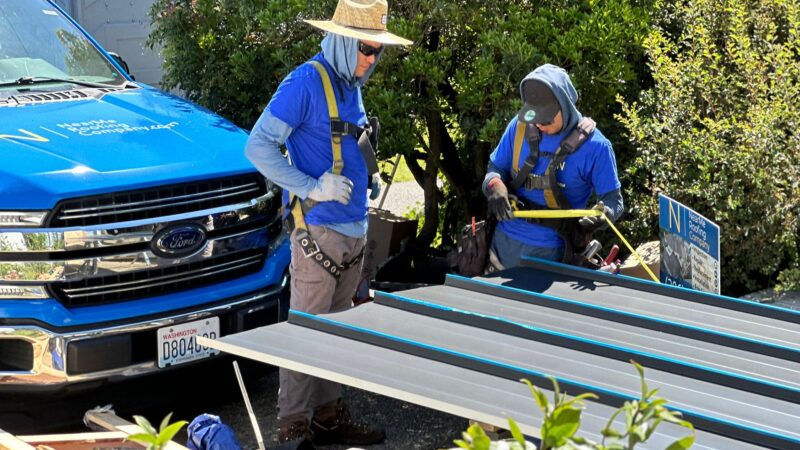 a group of roofing experts wearing blue shirts and hats