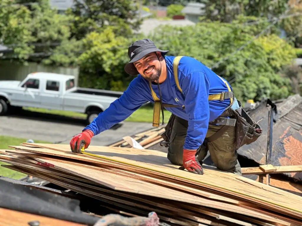 a roofer with roofing sheets