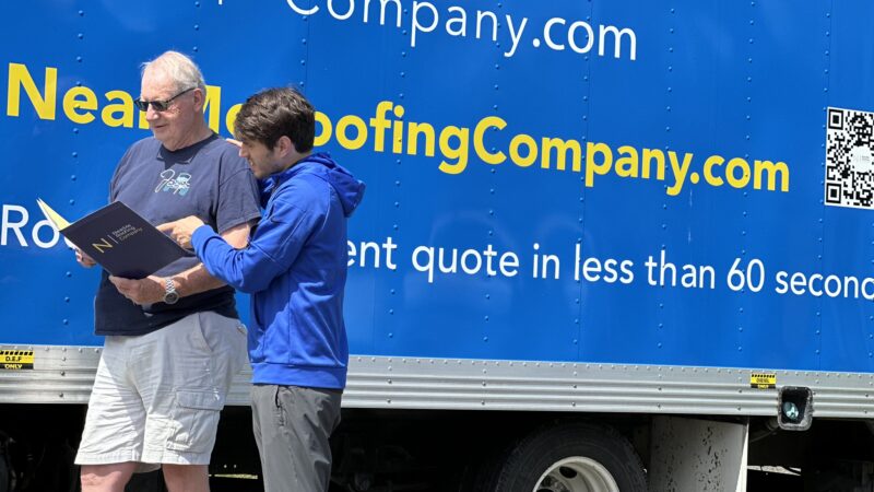 two men from nearme roofing company discussing a project