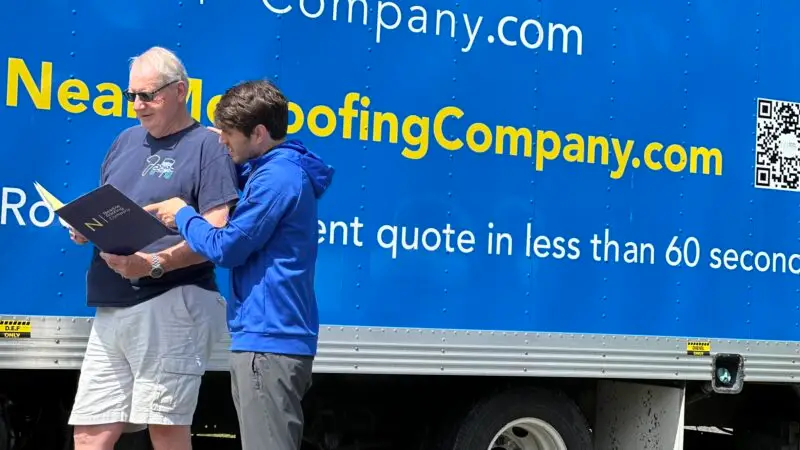 two men from nearme roofing company discussing a project