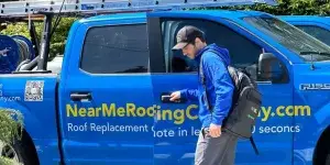 man wearing blue jacket and a blue hat open the door of a roofing van