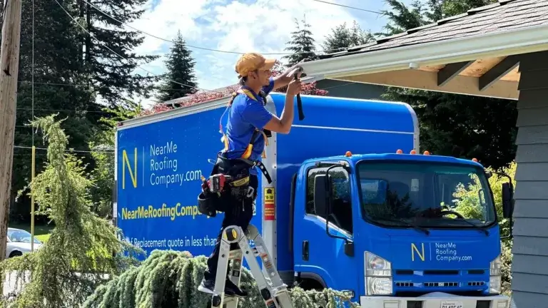 a man and a boy standing next to a blue truck