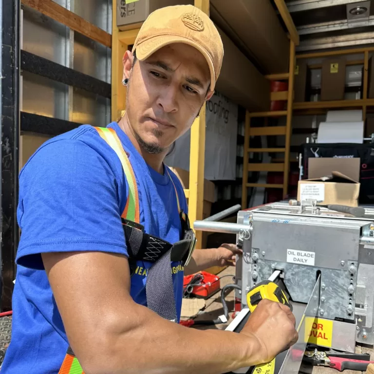 a roofing contractor in a blue shirt