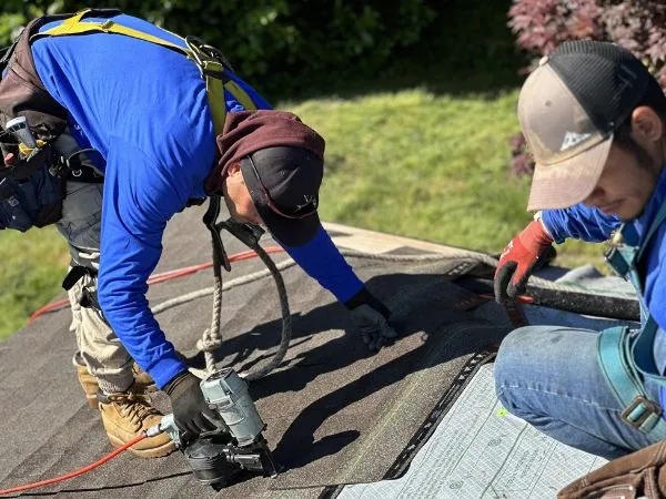 a group of men working on a leaky roof