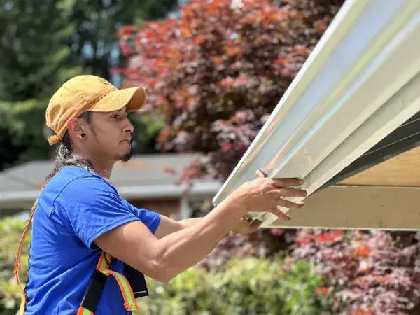 our roofer installing a gutter guard