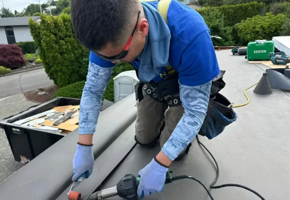 man in a blue shirt installing a roof